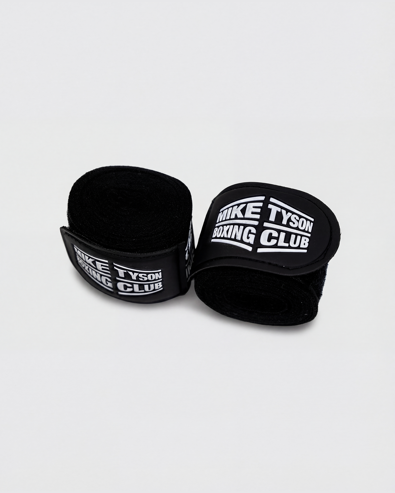 Black boxing hand wraps with the Mike Tyson Boxing Club logo in white on the wrap closure.