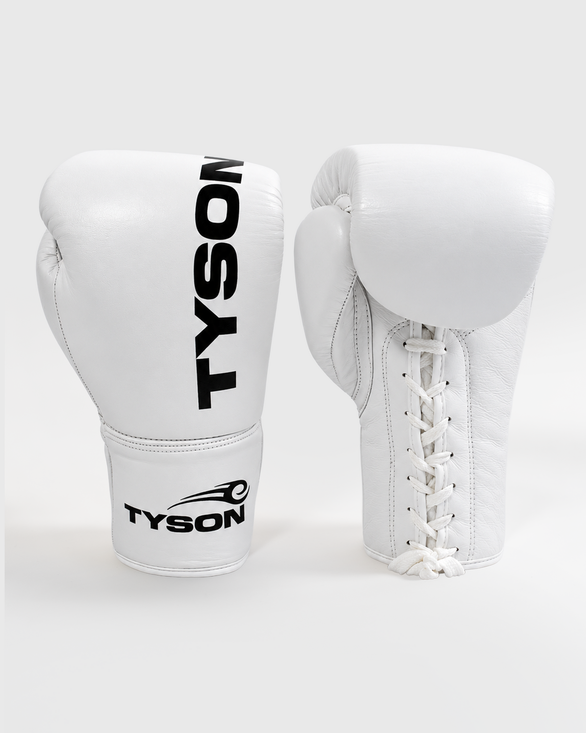 White boxing gloves. Black text saying "Tyson" runs vertically towards the fingers on the back of the gloves, while the Tyson Pro logo is on the wrist. The palm side of the glove features laces.