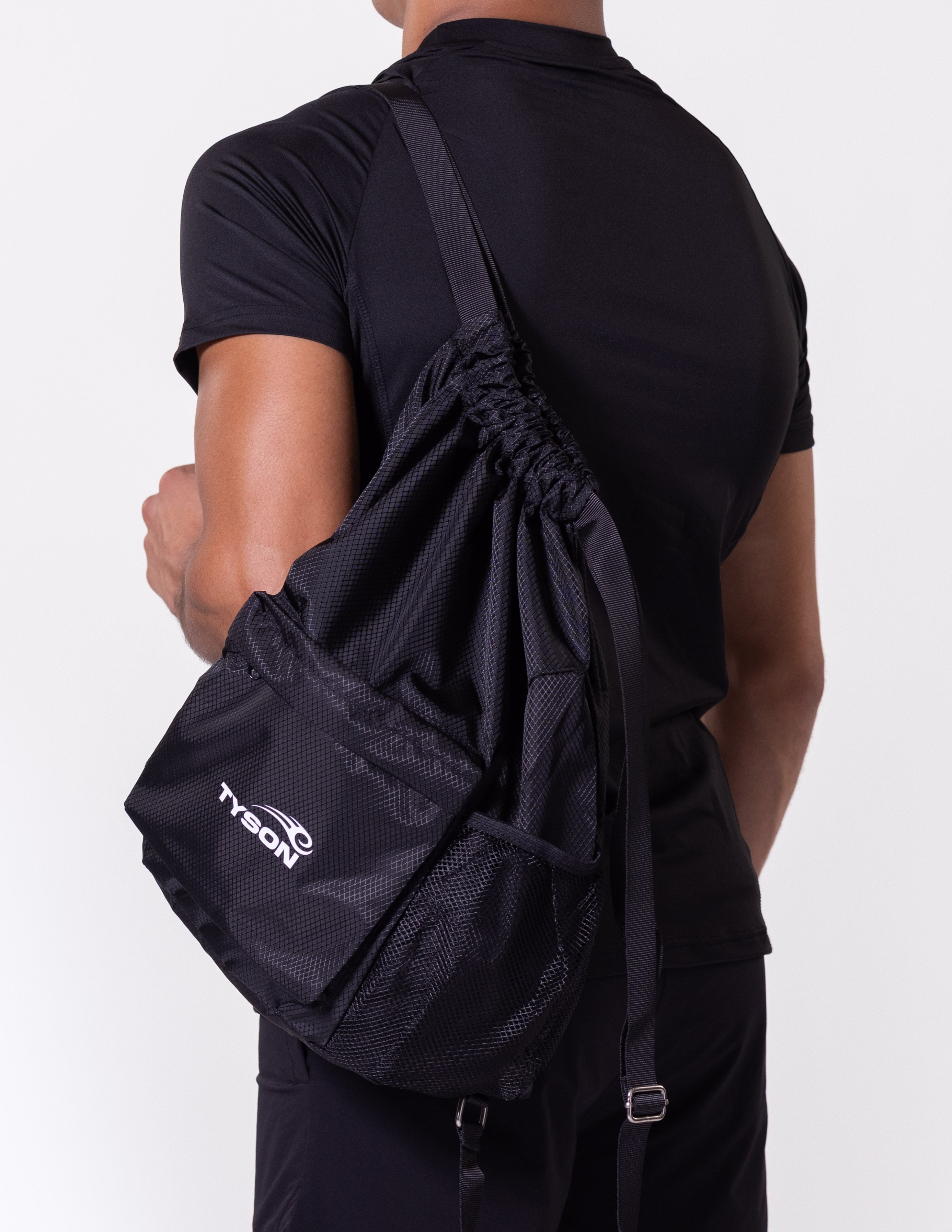 Black drawstring bag featuring the Tyson Pro logo in white on the front pocket panel. The bag has two mesh pockets on either side.
