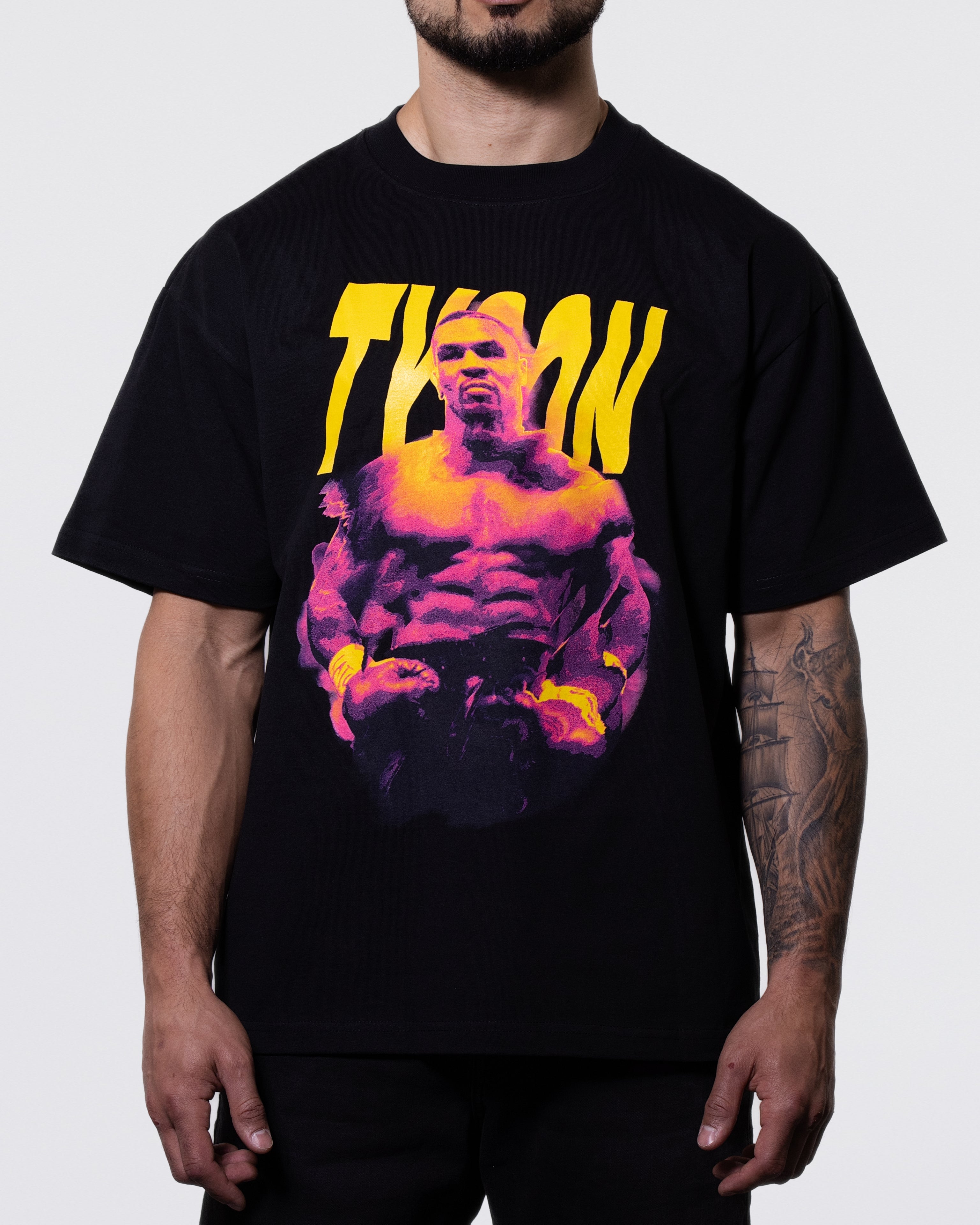 Black T-shirt with a fierce image of Mike, ready to fight. The image has red and blue highlights reminiscent of a mirage in the desert. "Tyson" is written behind the image.