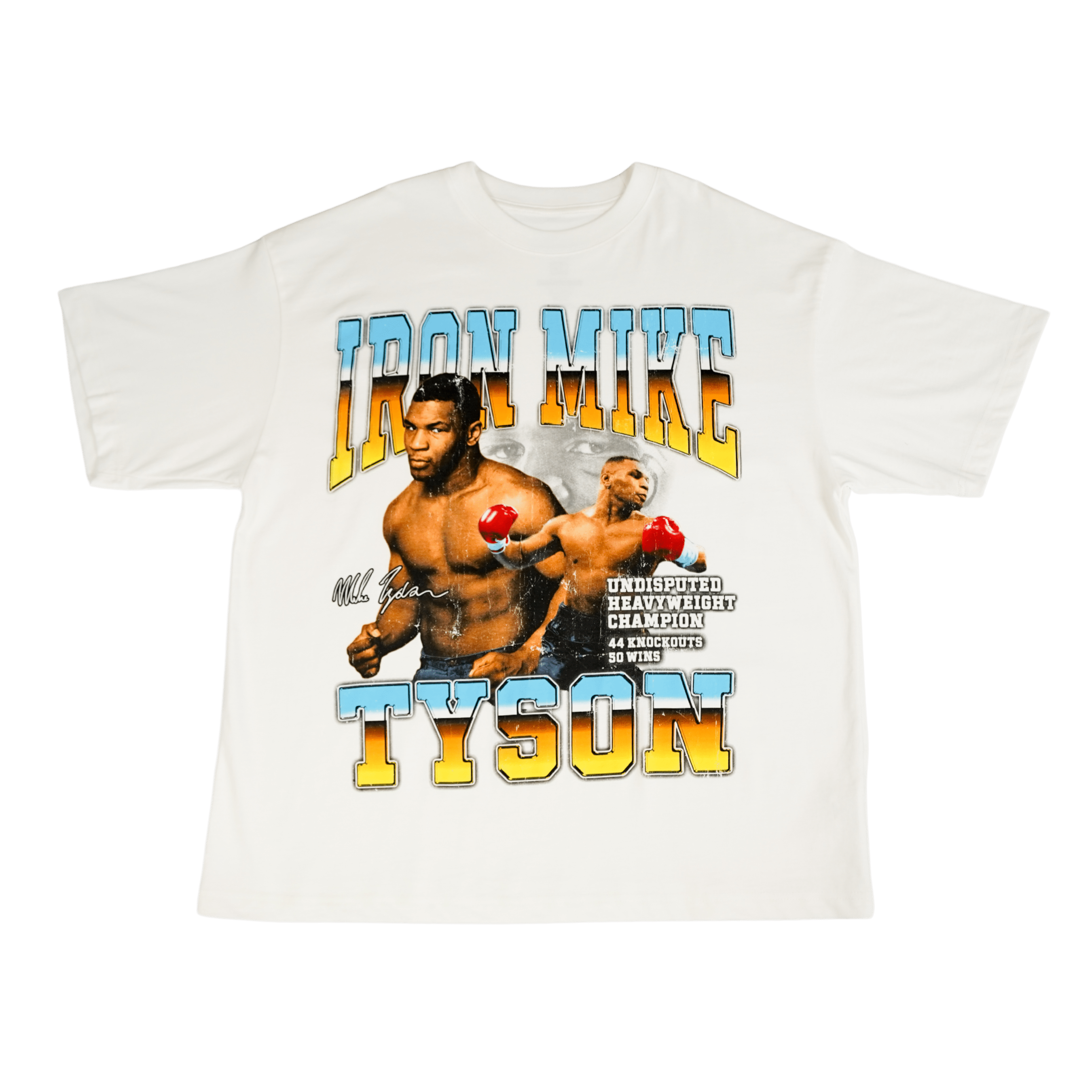 White T-shirt with three images if Mike. One is mid-fight, the other is posing for a photo, and the third is of his eyes in the background. Text above and below the image says Iron Mike Tyson, Undisputed Heavyweight Champion. 44 Knockouts, 50 wins. His signature is on the left.