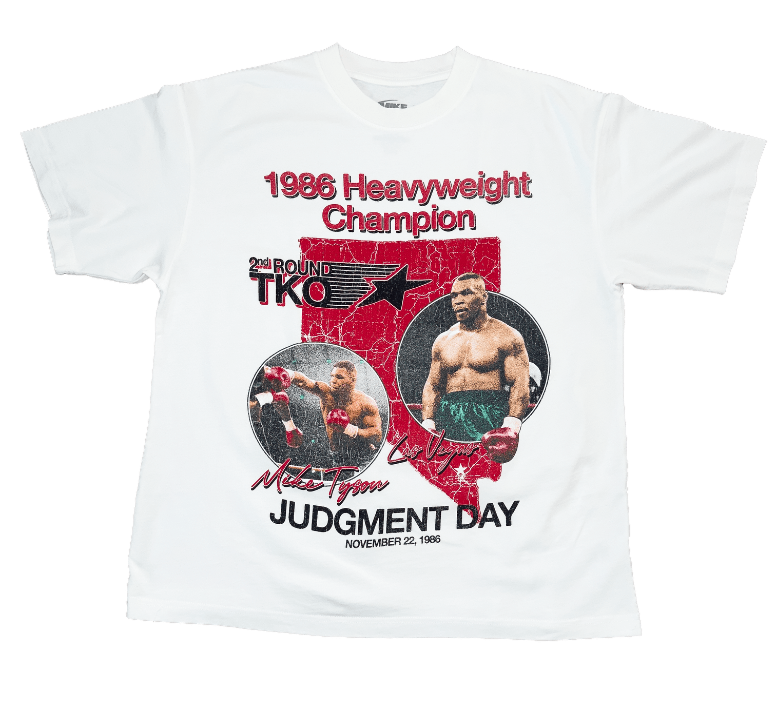 White T-shirt with the state of Nevada in red in the background, with two images of Mike in the foreground. 1986 Heavyweight Champion is written across the top and Judgement Day November 22, 1986 is at the bottom. Other text surrounding the images include 2nd round TKO, Mike Tyson, and Las Vegas.