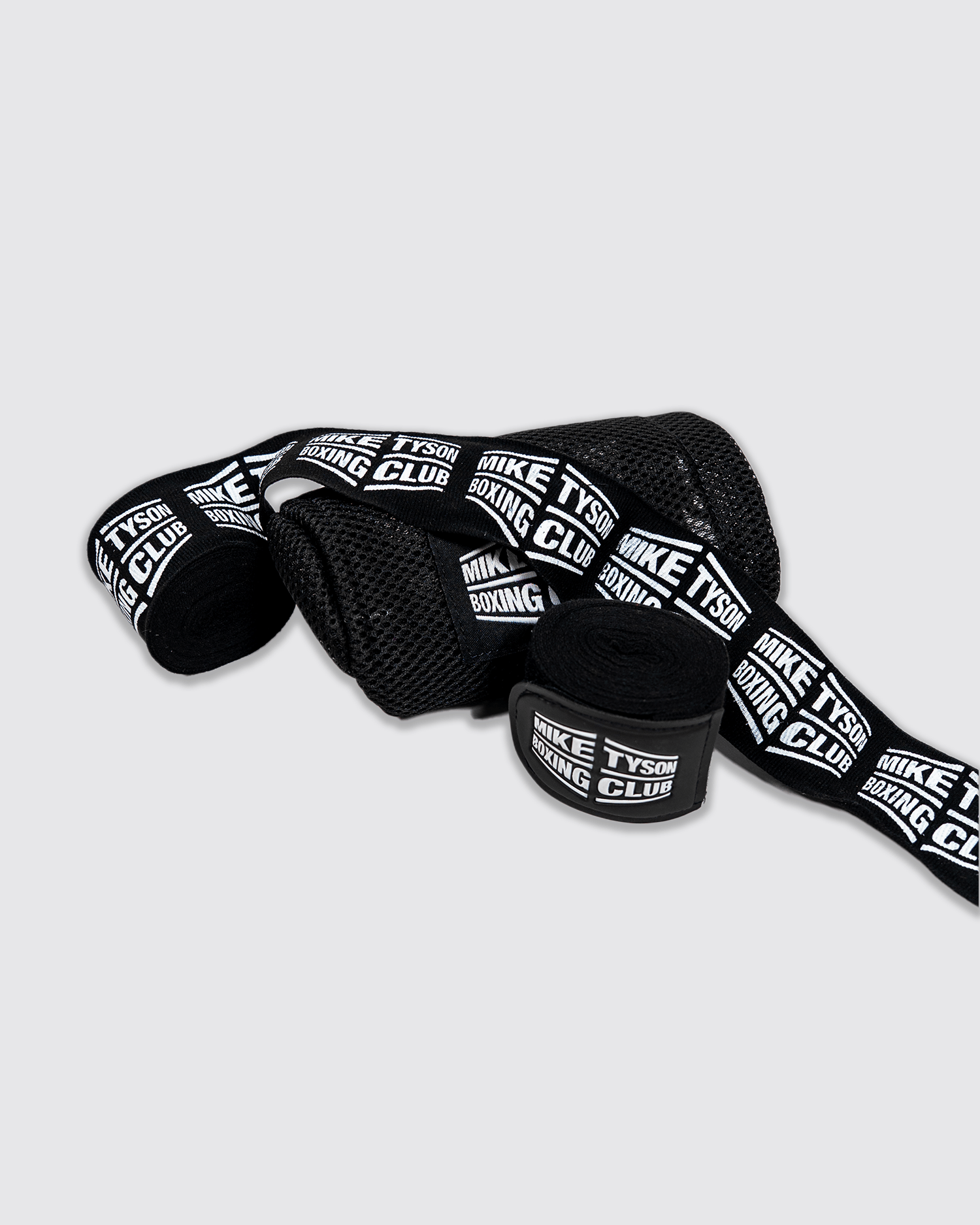 Black boxing hand wraps with the Mike Tyson Boxing Club logo in white along the entire wrap.