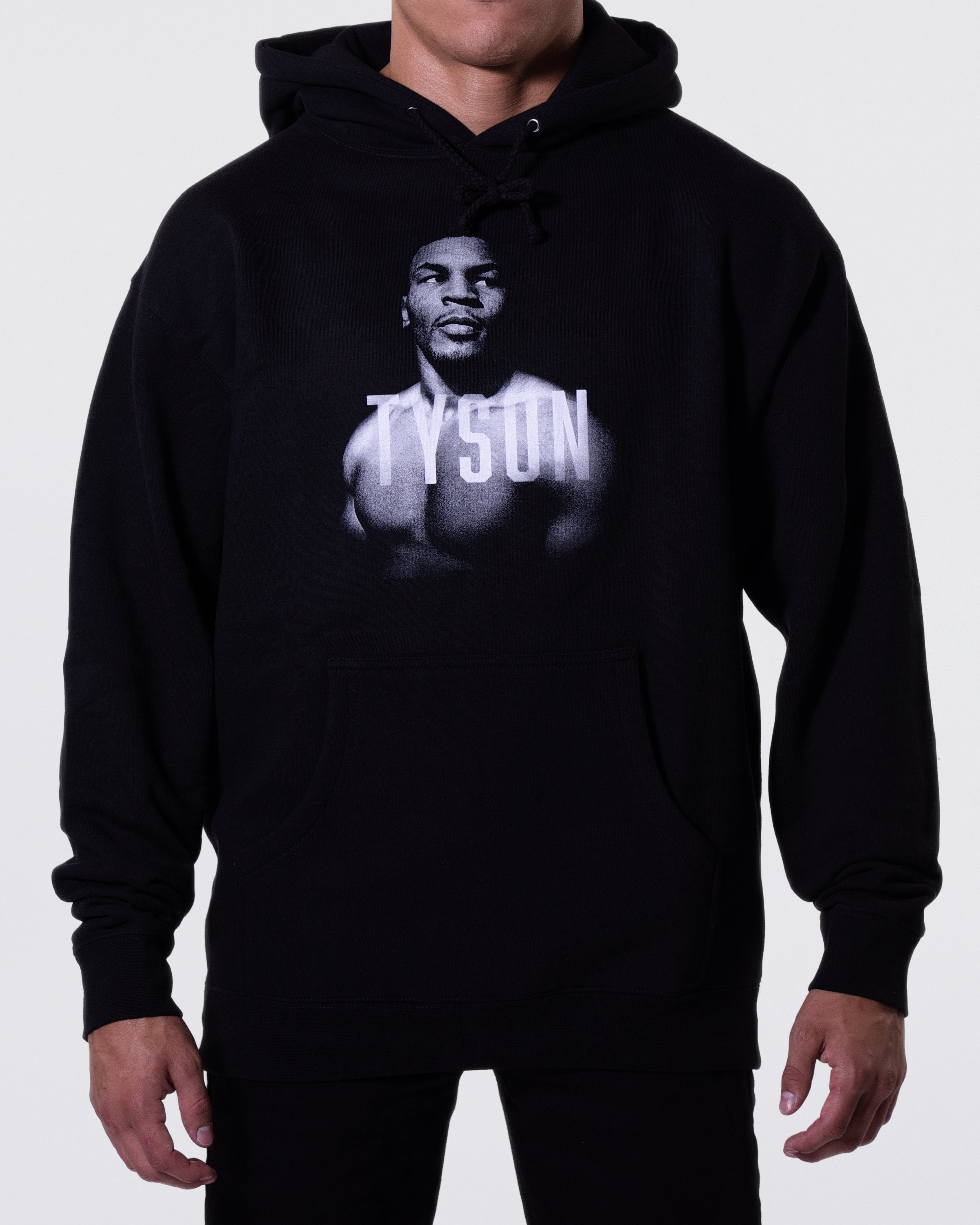 Black hoodie with a black and white portrait of Mike. His body is turned slightly to the left, his face is forward and his eyes are looking off to the right. Slightly transparent white text saying Tyson is featured across his upper chest.