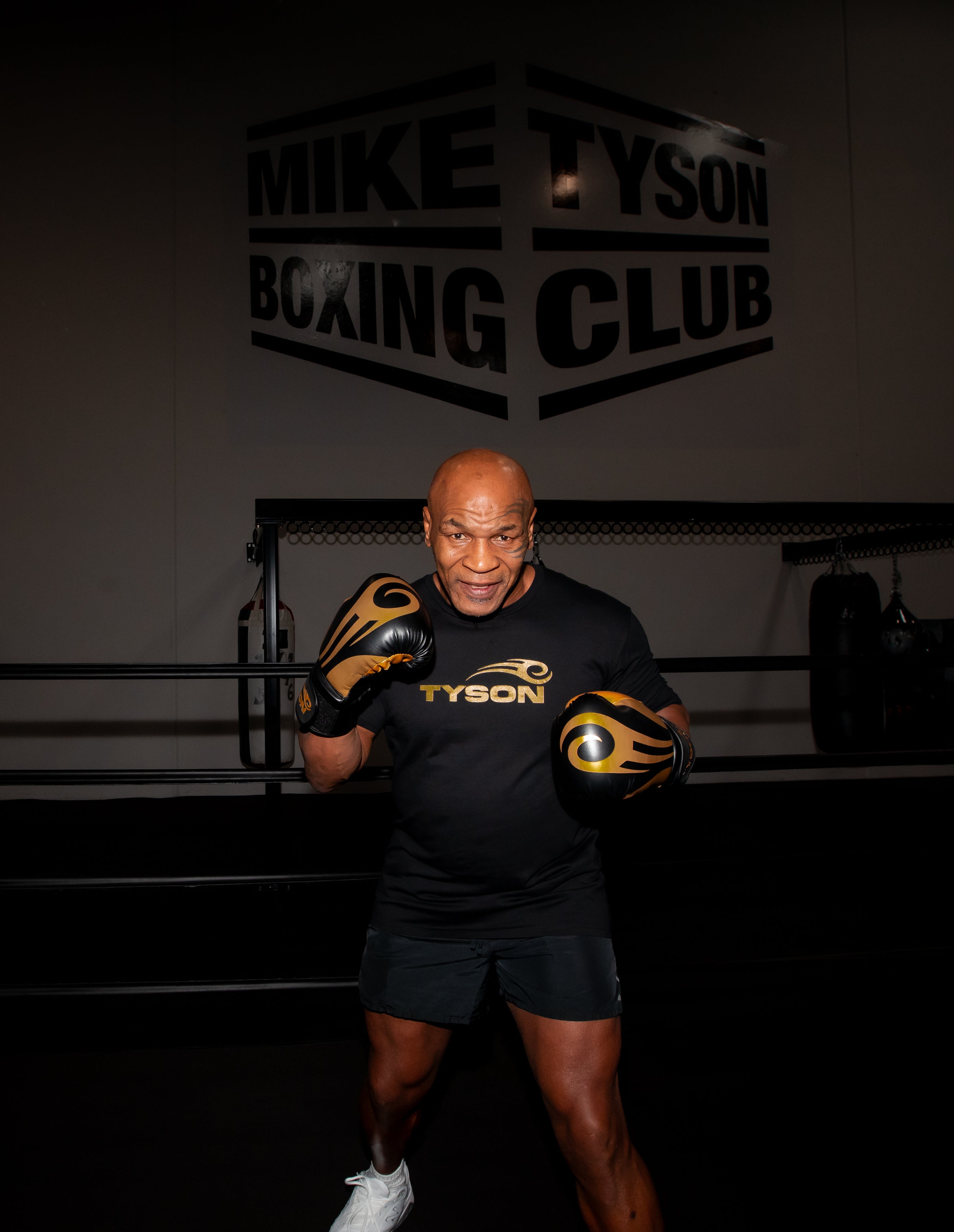 Mike Tyson wearing the Tyson Pro Cotton Shirt Black with Gold Logo.