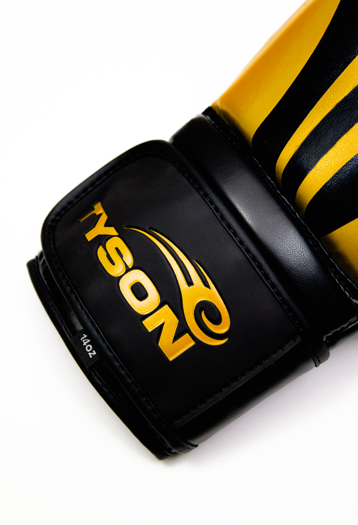 Black boxing gloves with gold accents. The Tyson half tribal logo is featured on the back of the gloves and the Tyson Pro logo is on the wrist strap. The palm area has mesh.