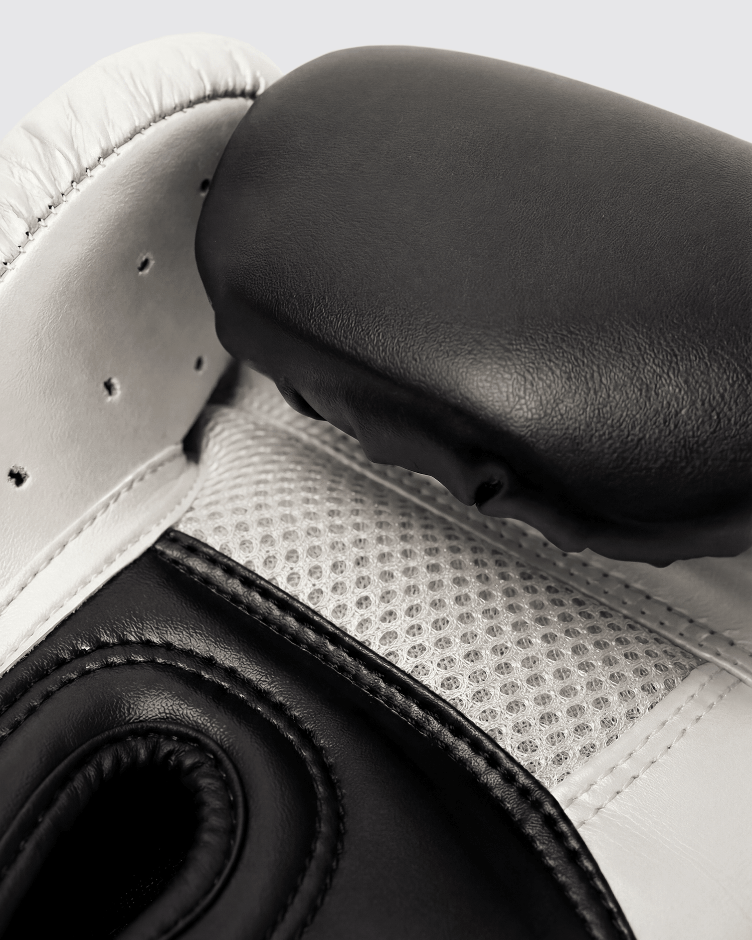 Black boxing gloves with white accents. The Tyson half tribal logo is featured on the back of the gloves and the Tyson Pro logo is on the wrist strap. The palm area has mesh.
