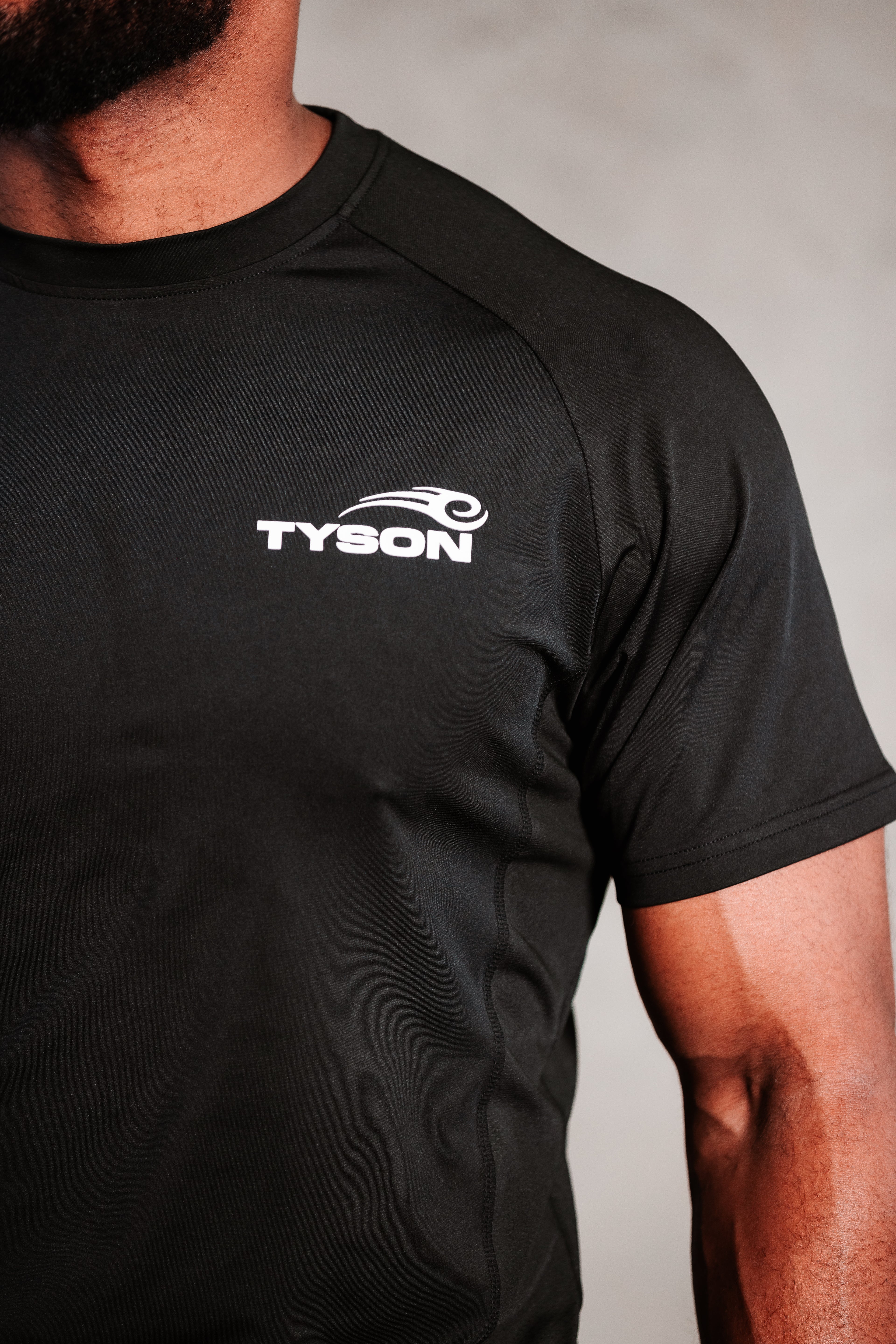 Black T-shirt featuring the Tyson Pro logo in white on the left chest area.