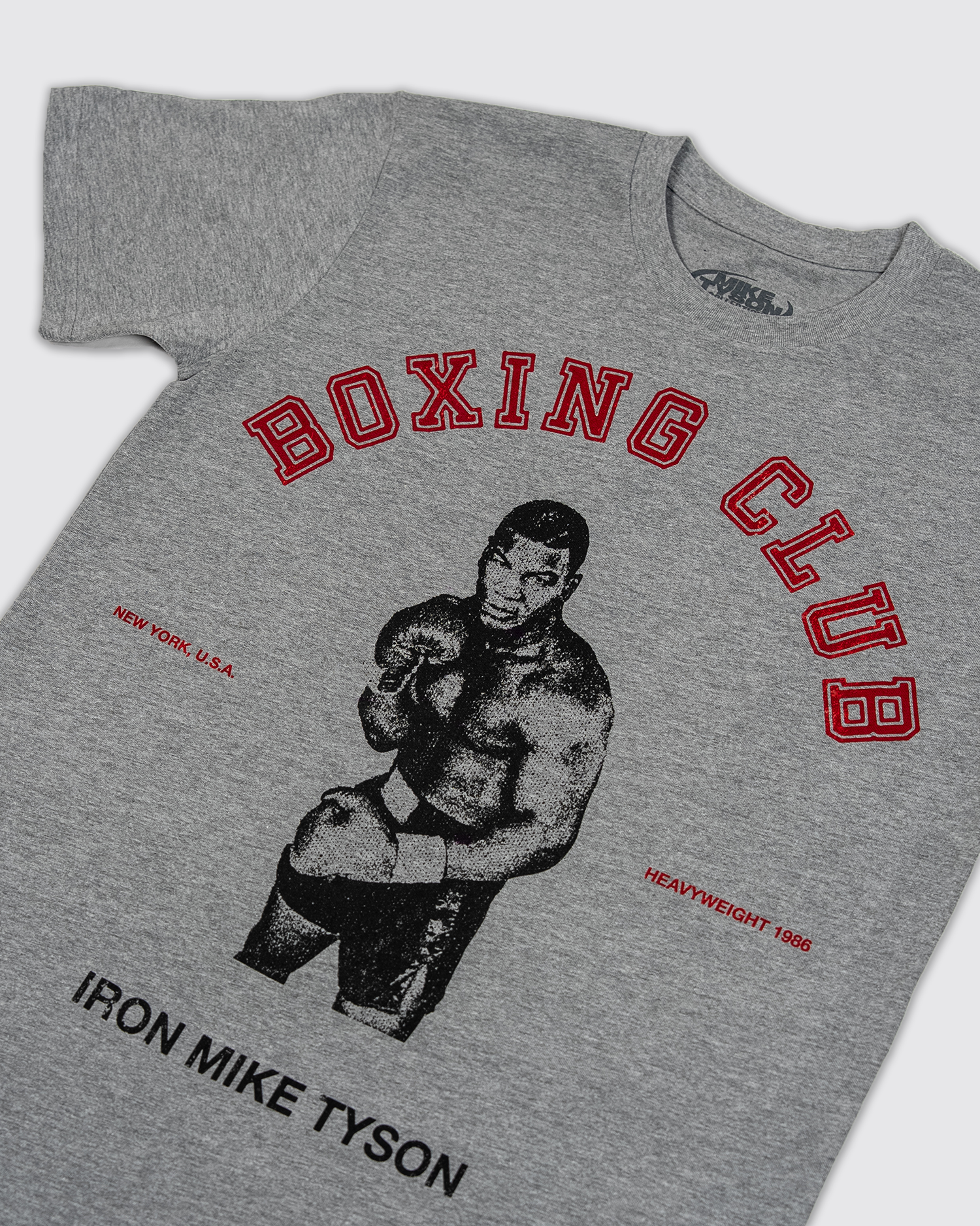Front design: Gray t-shirt with image of Mike Tyson in the middle, with red "Boxing Club" text over the top, "New York, USA" and "Heavyweight 1986" on the right and left, and black "Iron Mike Tyson" text below.