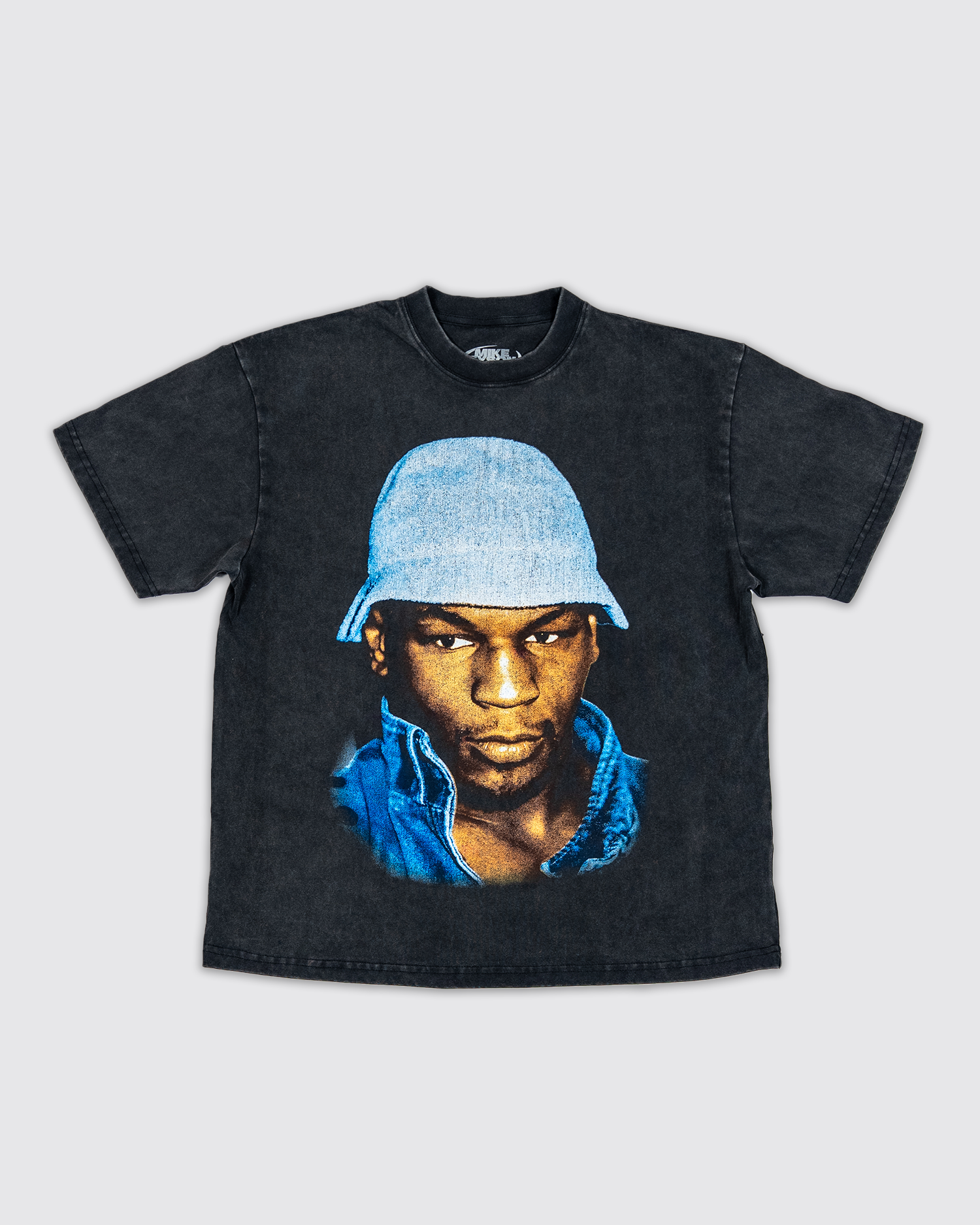 Front design: Black snowwash t-shirt with a graphic of Mike Tyson wearing a blue bucket hat.