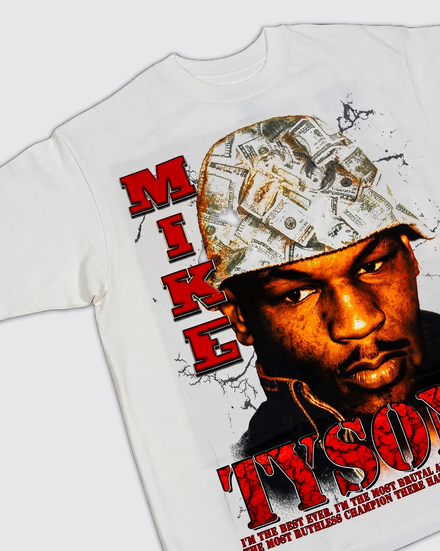 Front design: White t-shirt with a graphic of Mike Tyson wearing a bucket hat with money printed all over it. Red "Mike Tyson" text runs down the left and bottom of the shirt with the quote "I'm the best ever. I'm the most brutal and vicious, the most ruthless champion there has ever been" running below. 