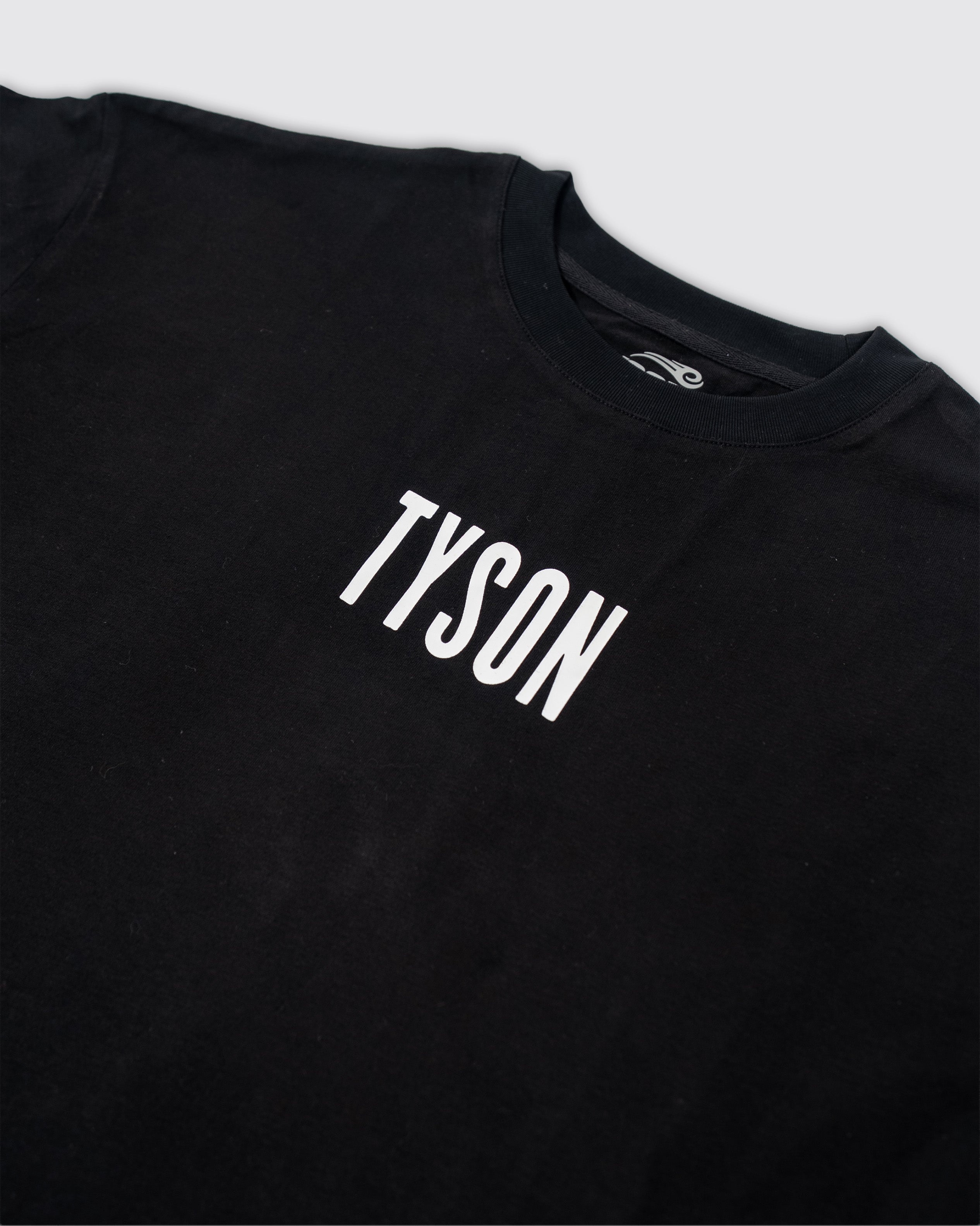 Black t-shirt with small white "Tyson" text across the chest.