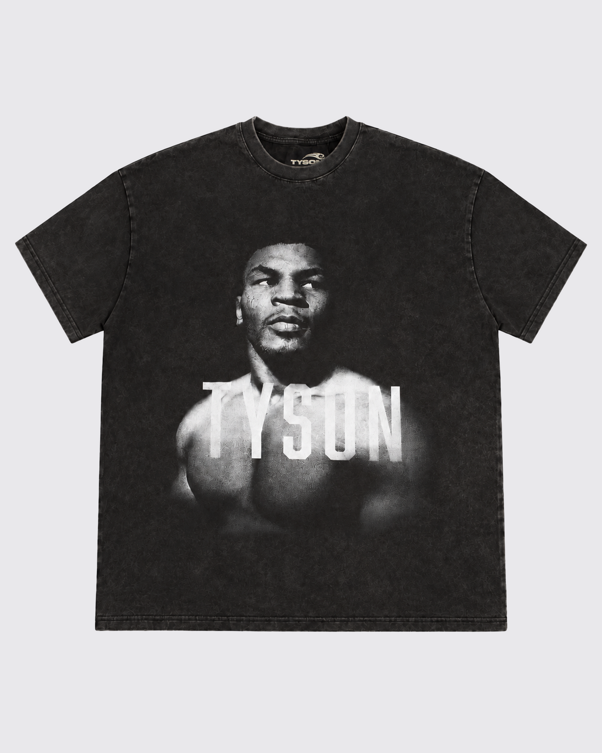 Black, Snow Wash T-shirt with a black and white portrait of Mike. His body is turned slightly to the left, his face is forward and his eyes are looking off to the right. Slightly transparent white text saying "Tyson" is featured across his upper chest. 