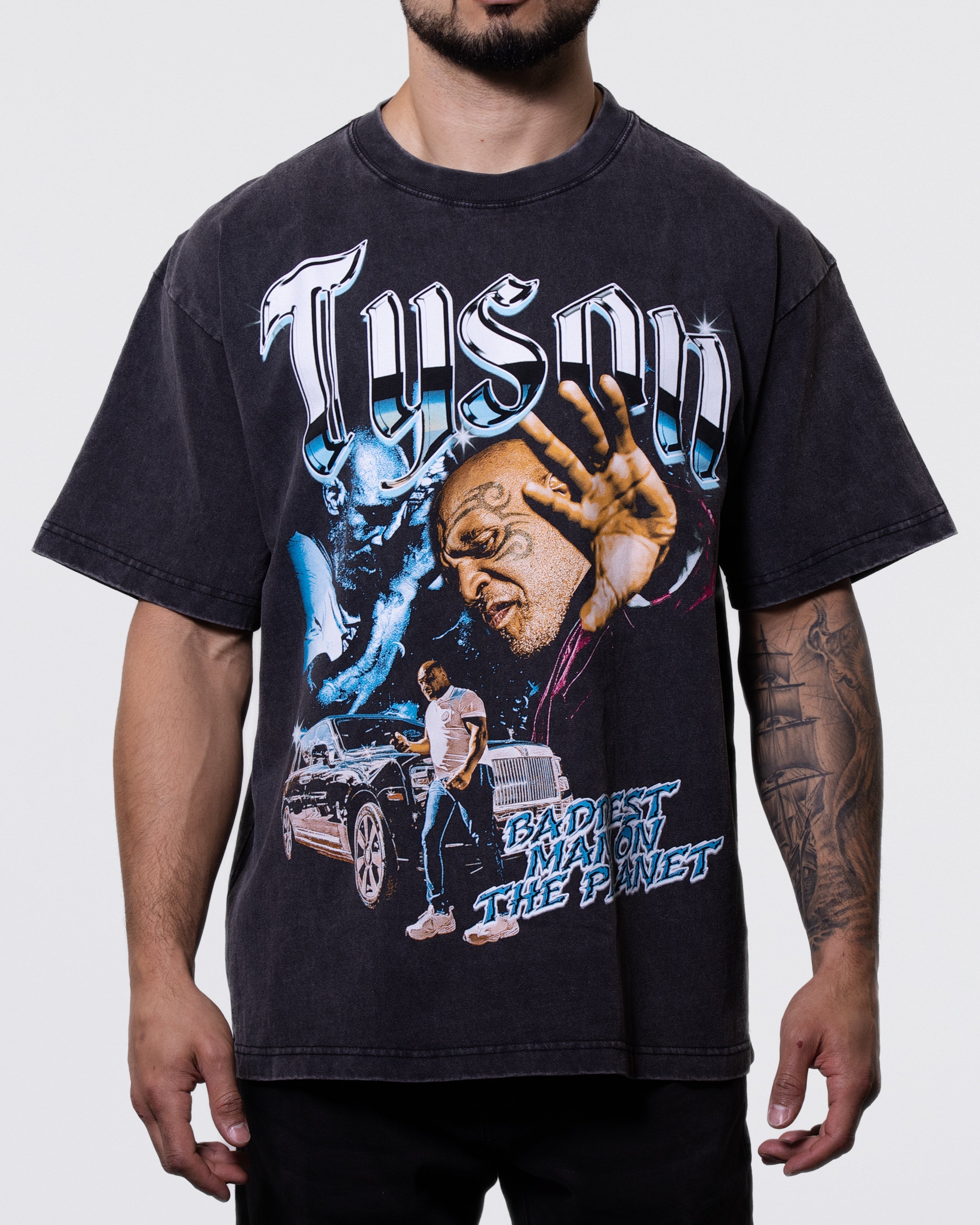 Black, Snow Wash T-shirt with 3 images of Mike. "Tyson" is written across the top along with "Baddest Man on the Planet" written below. 