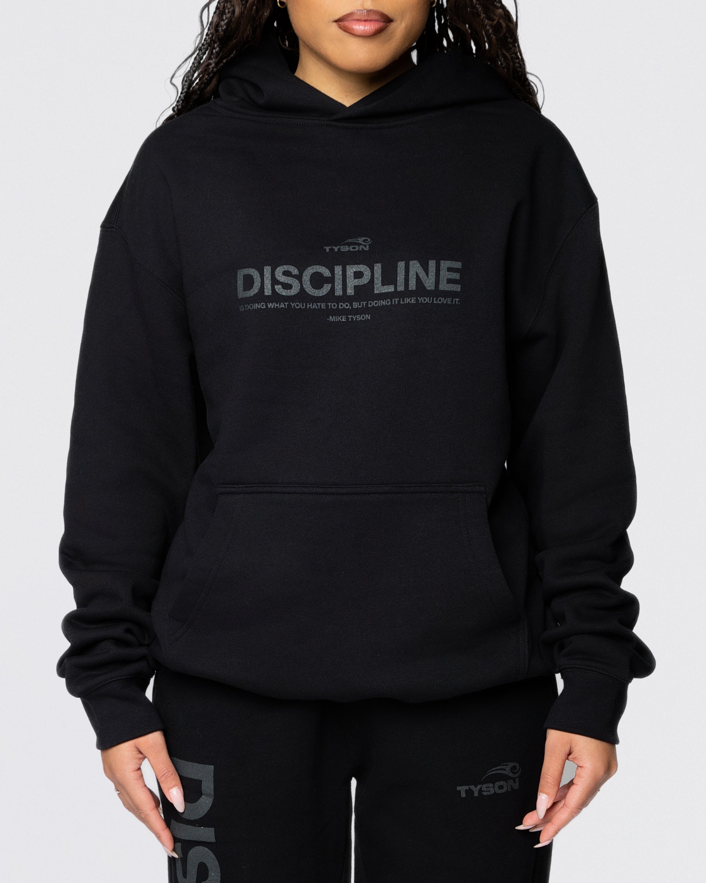 Black hoodie with the large text "Discipline" written across the chest, with the remainder of the quote "is doing what you hate to do, but doing it like you love it - Mike Tyson" written smaller below.