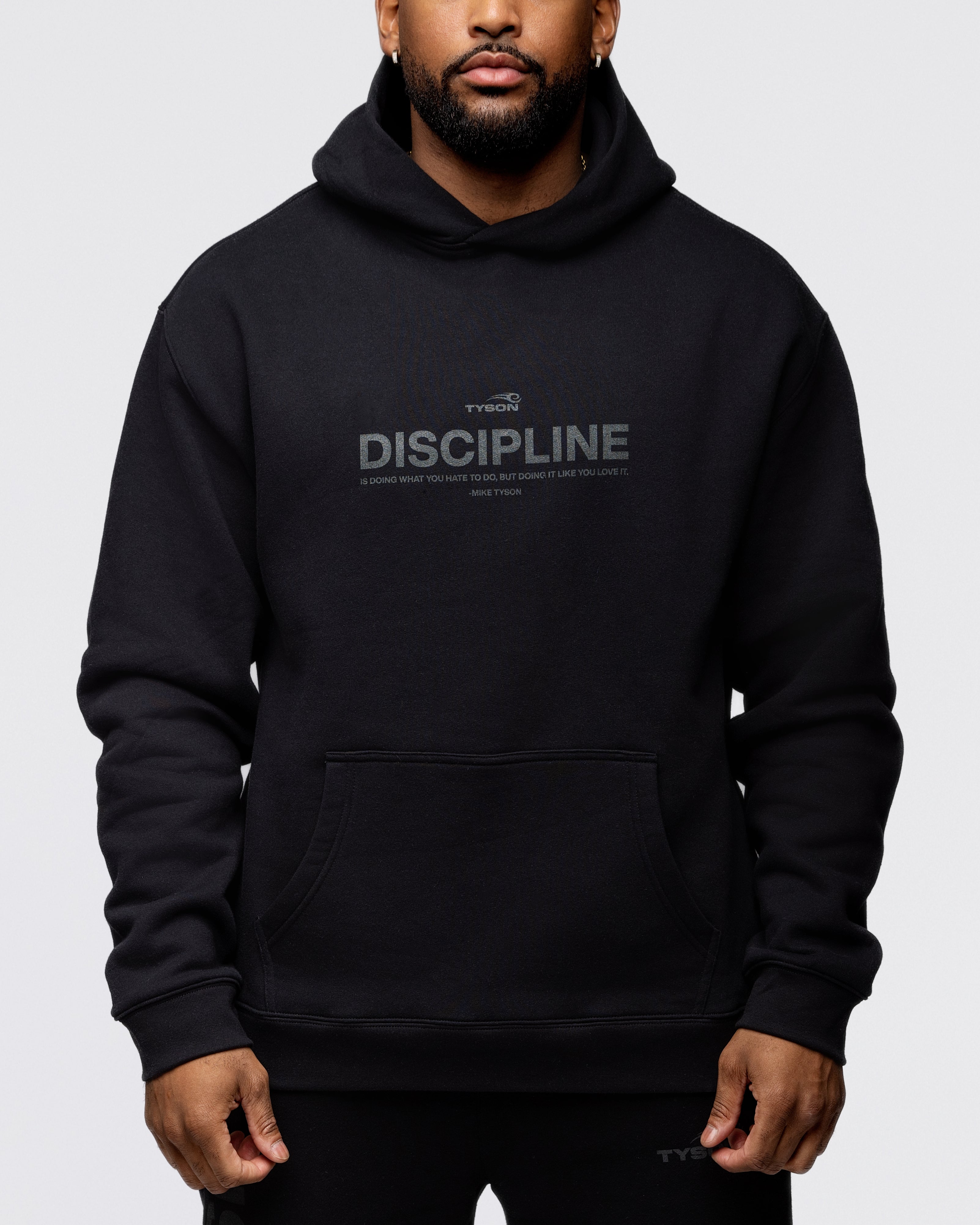 Black hoodie with the large text "Discipline" written across the chest, with the remainder of the quote "is doing what you hate to do, but doing it like you love it - Mike Tyson" written smaller below.