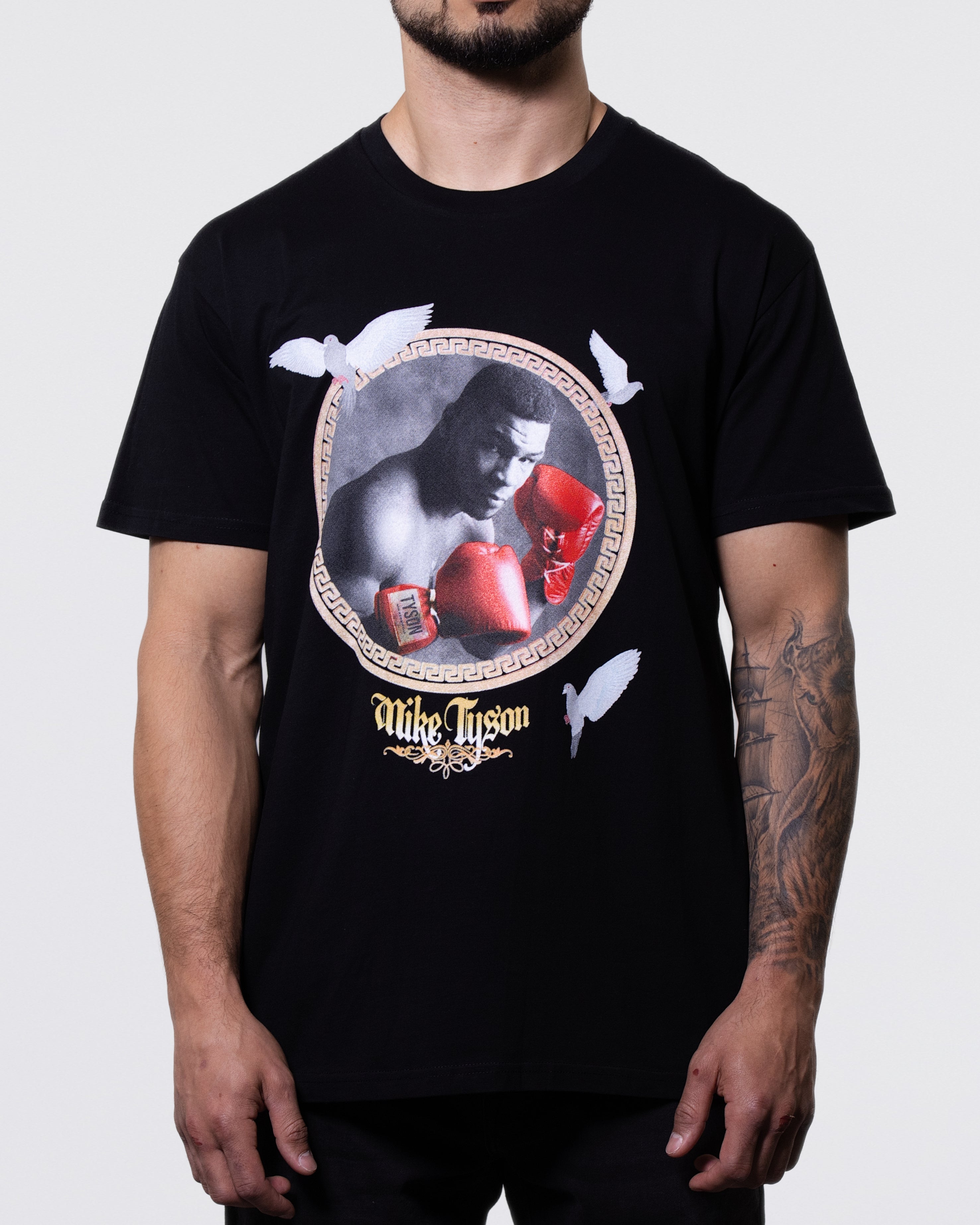 Black T-shirt with a framed photo of Mike wearing red gloves with his name below. Three pigeons surround the frame.