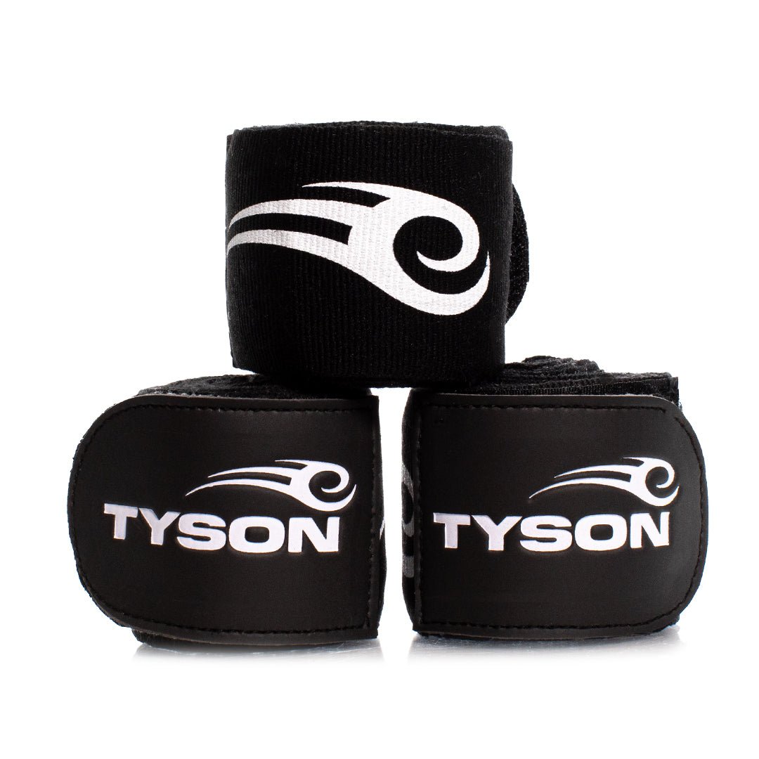 Black hand wraps with the Tyson Pro logo in white on the strap, and the Tyson half tribal logo repeatedly running along the entire wrap. 