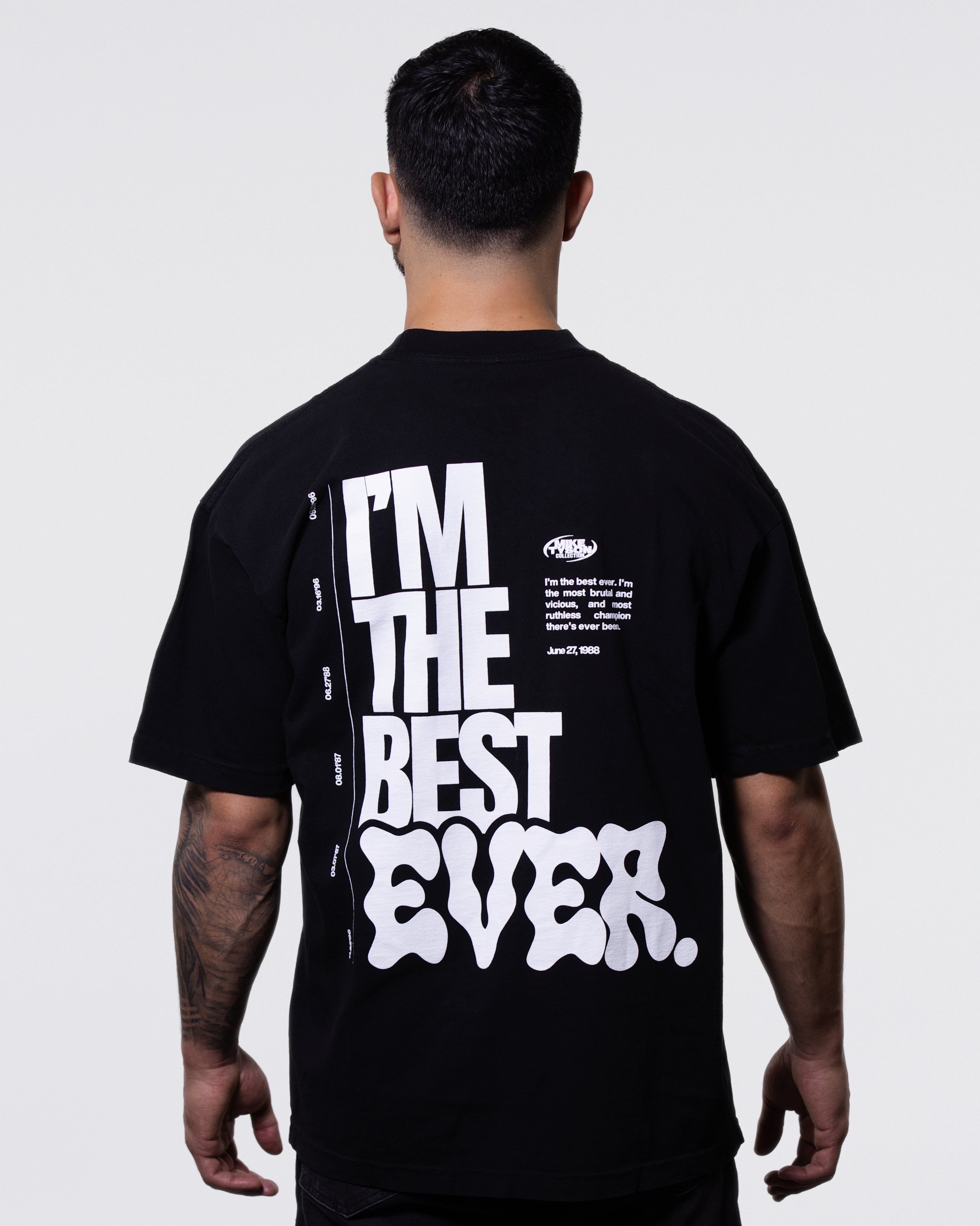 Black T-shirt. The back largely features the Mike Tyson quote "I'm the Best Ever" with the belt dates running down the left. In the upper right, the quote continues in smaller writing: "I'm the Best Ever. I'm the Most Brutal and Vicious, and Most Ruthless Champion There's Ever Been." 