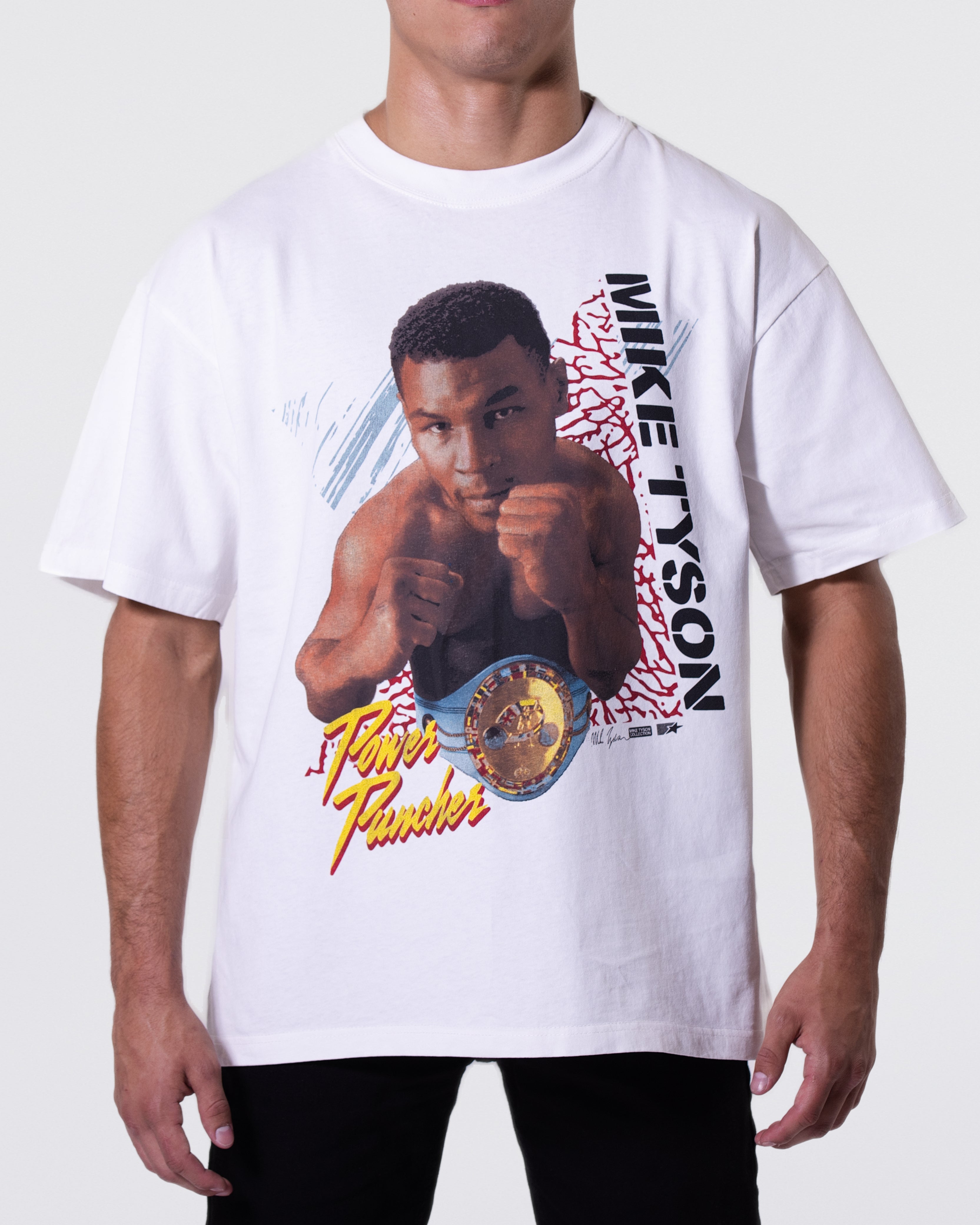 White T-Shirt with an image of Mike in the center wearing a title belt. The shirt features text that says "Mike Tyson" and "Power Puncher."