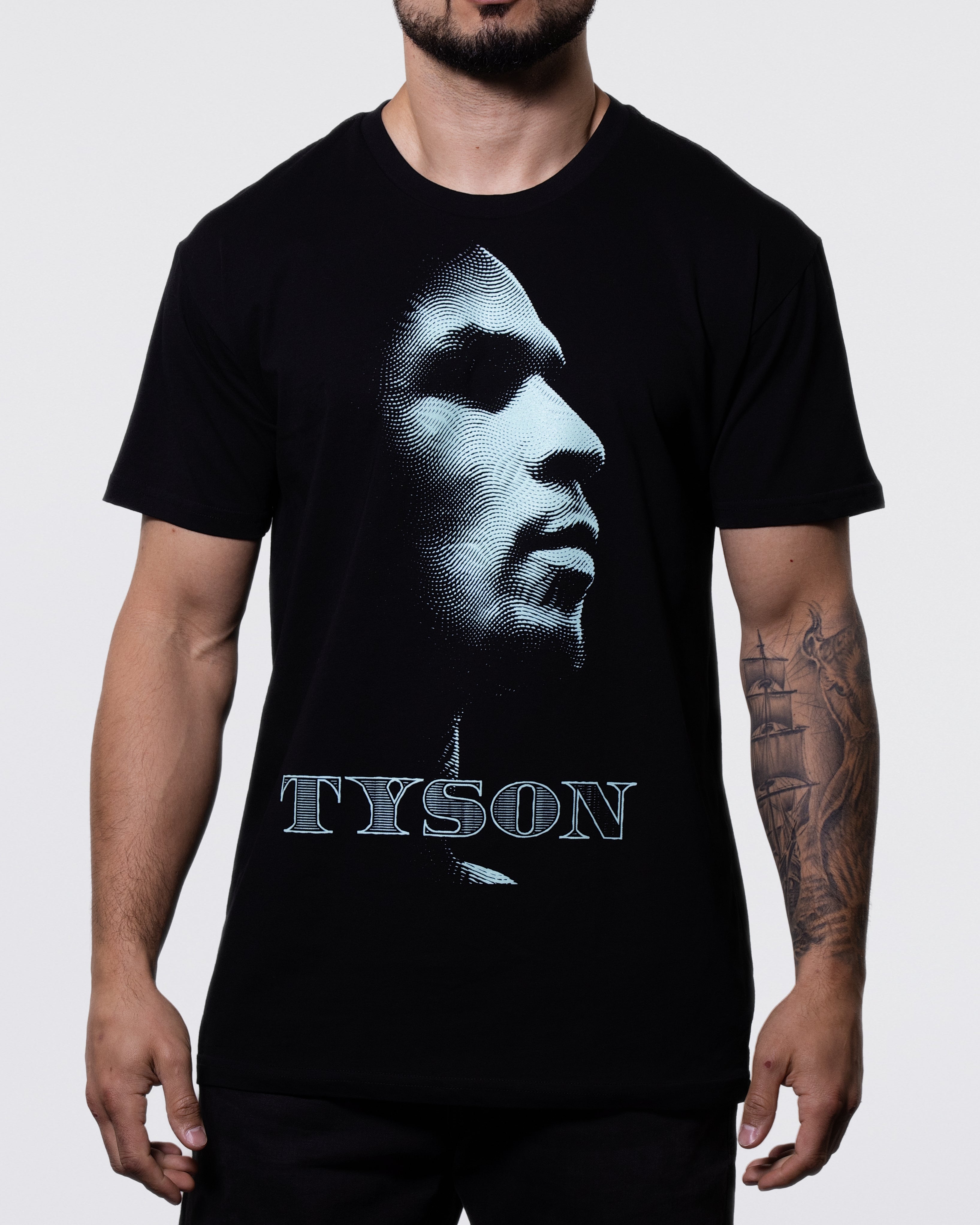 Black T-shirt with Mike's side profile in the center, and "Tyson" written across the bottom. The design is green and has a patterned effect to represent the likeness of money.