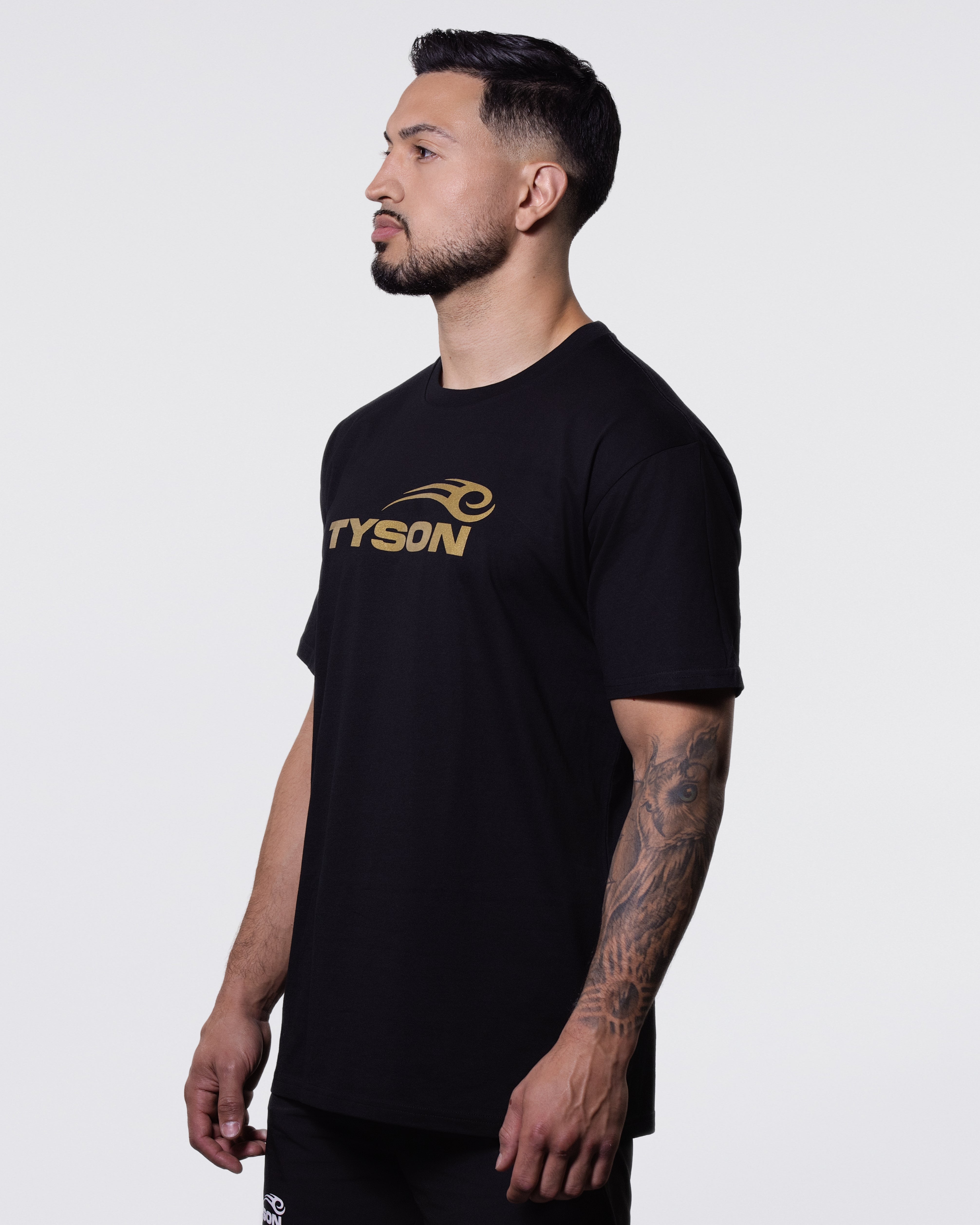 Model wearing the Tyson Pro Cotton Shirt - Black (Gold Logo).