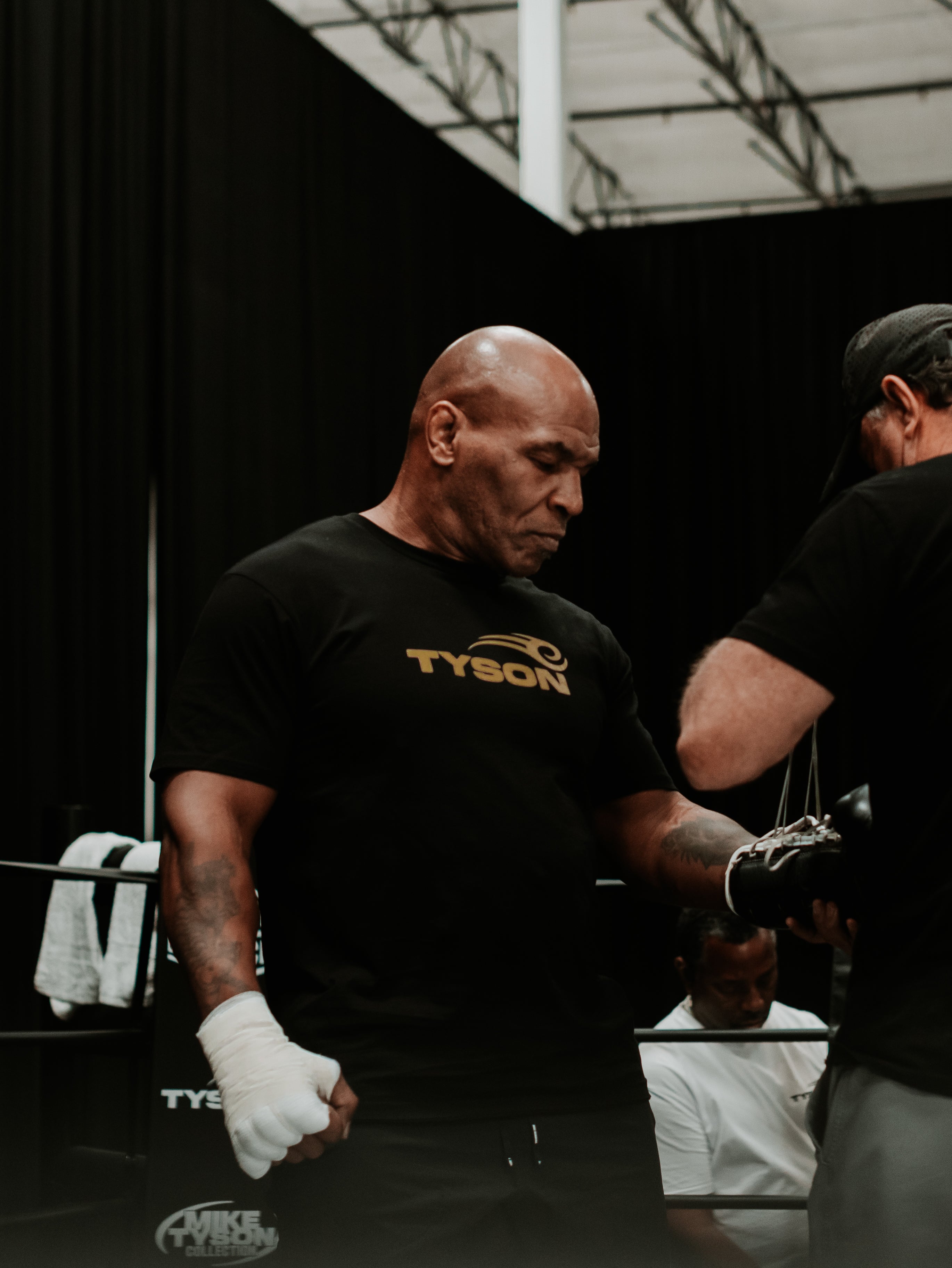 Mike Tyson wearing the Tyson Pro Cotton Shirt Black with Gold Logo.