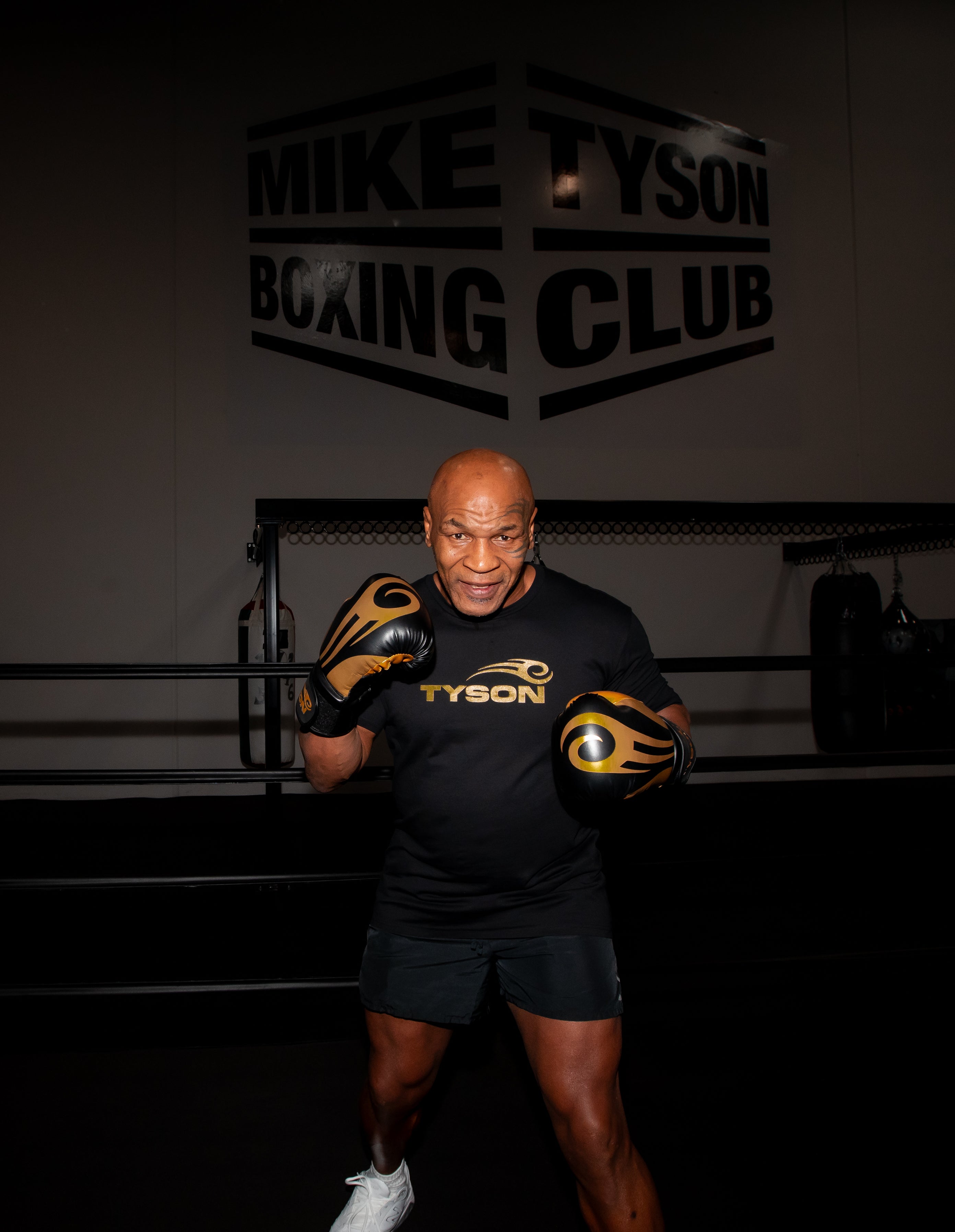 Mike Tyson wearing the Tyson Pro Cotton Shirt Black with Gold Logo.