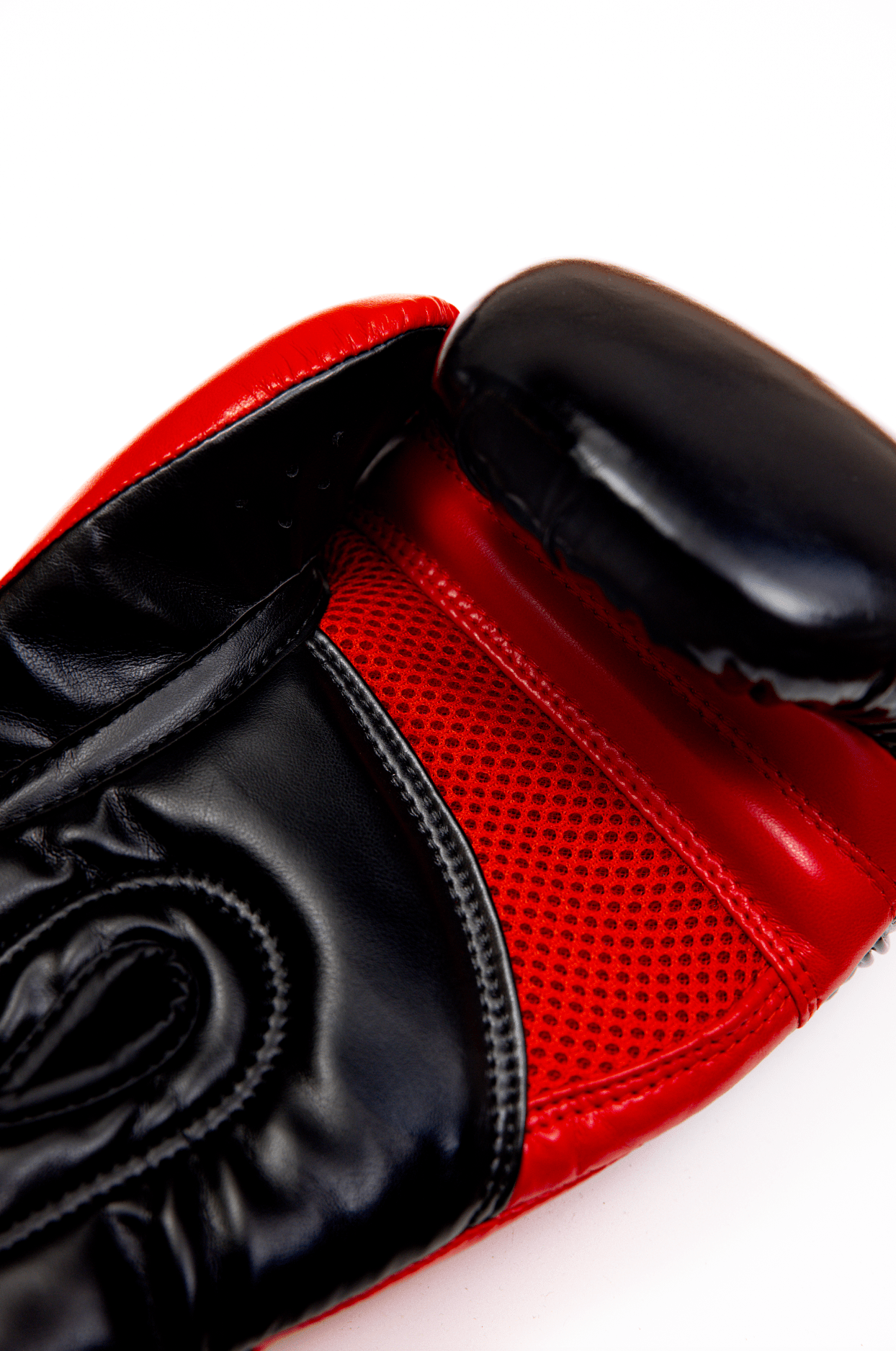 Black boxing gloves with red accents. The Tyson half tribal logo is featured on the back of the gloves and the Tyson Pro logo is on the wrist strap. The palm area has mesh.