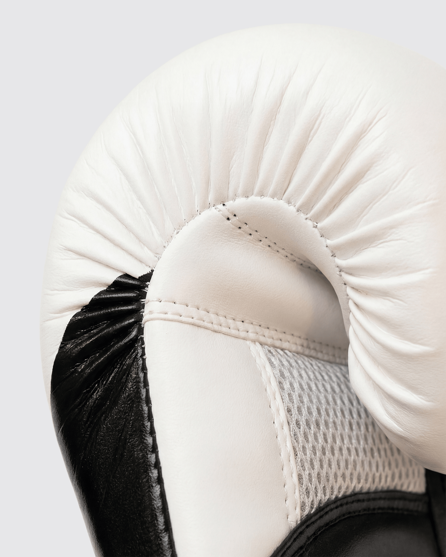 Black boxing gloves with white accents. The Tyson half tribal logo is featured on the back of the gloves and the Tyson Pro logo is on the wrist strap. The palm area has mesh.