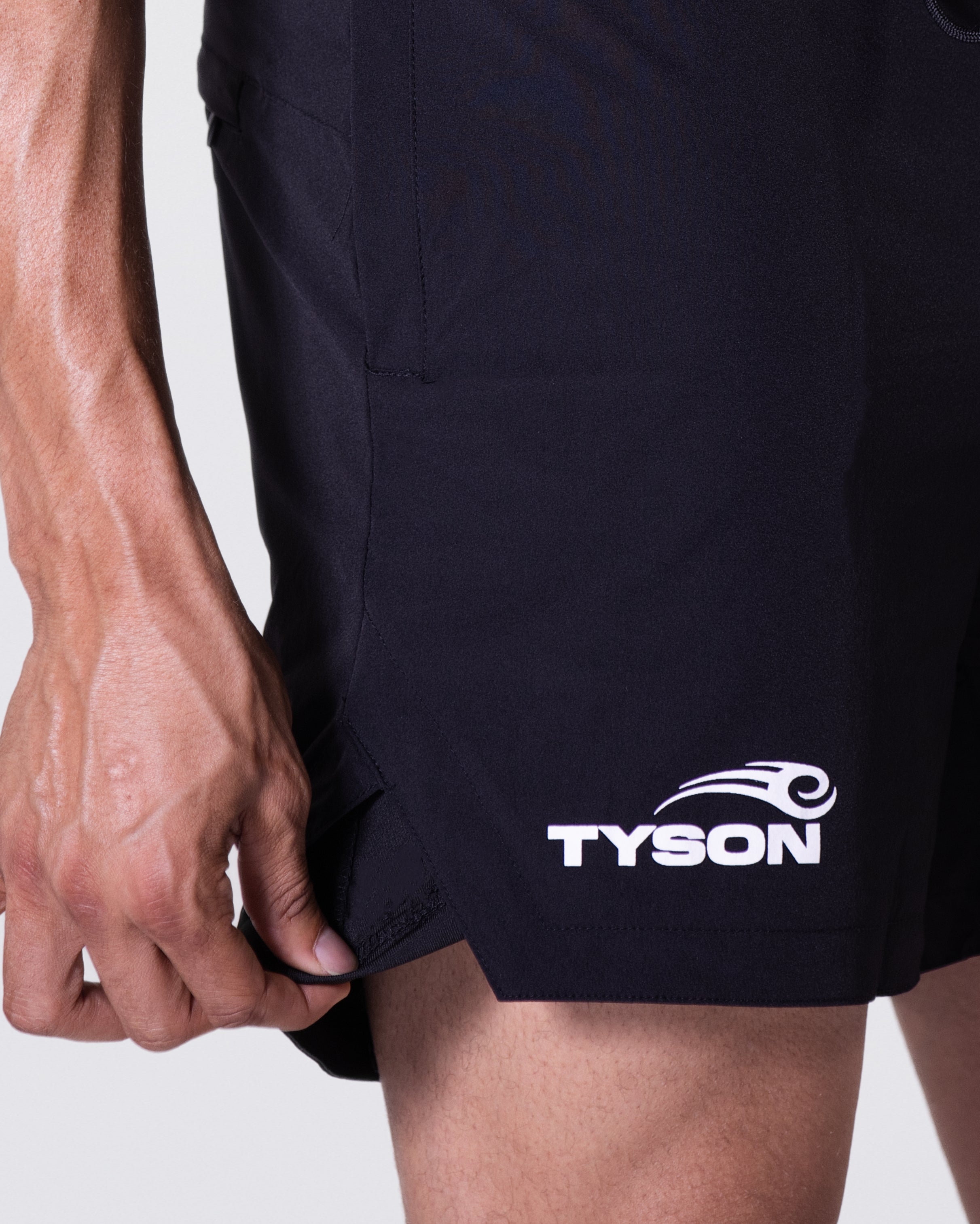 Black shorts featuring the Tyson Pro logo in white on the right thigh, just above the cuff.