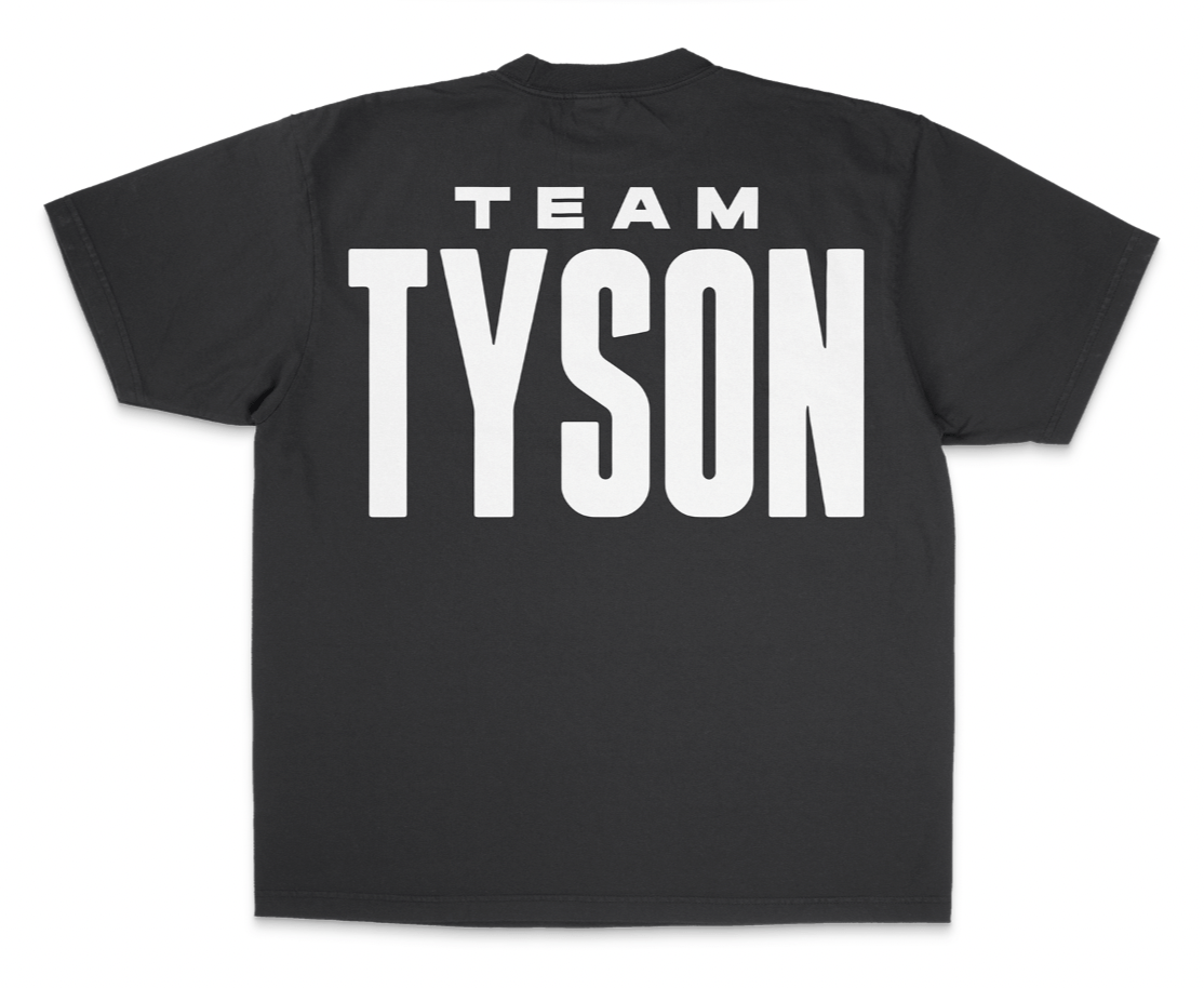 Black T-shirt. The back features white text that says "Team Tyson" and the front has the Tyson Pro logo small on the left chest area.