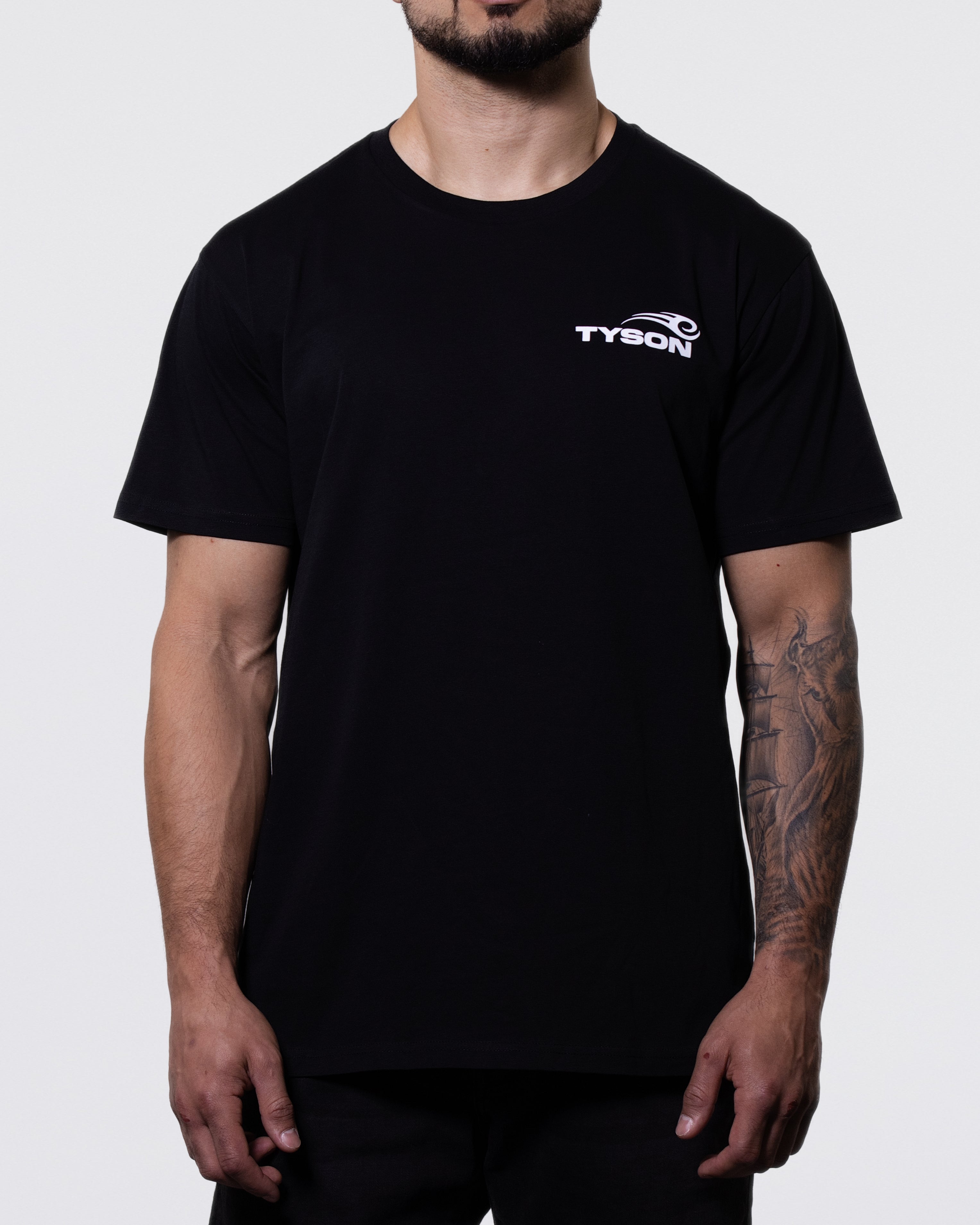 Black T-shirt. The back features white text that says "Team Tyson" and the front has the Tyson Pro logo small on the left chest area.